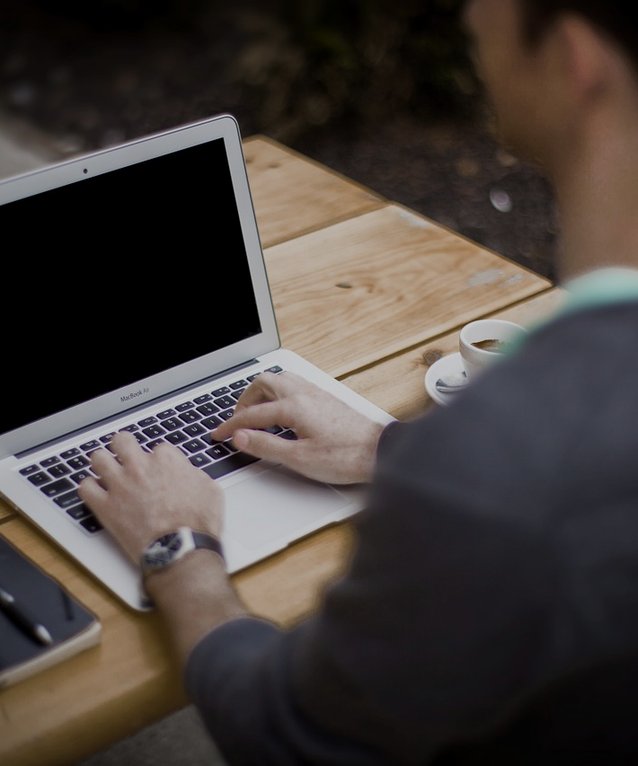 Typing on a laptop outdoors